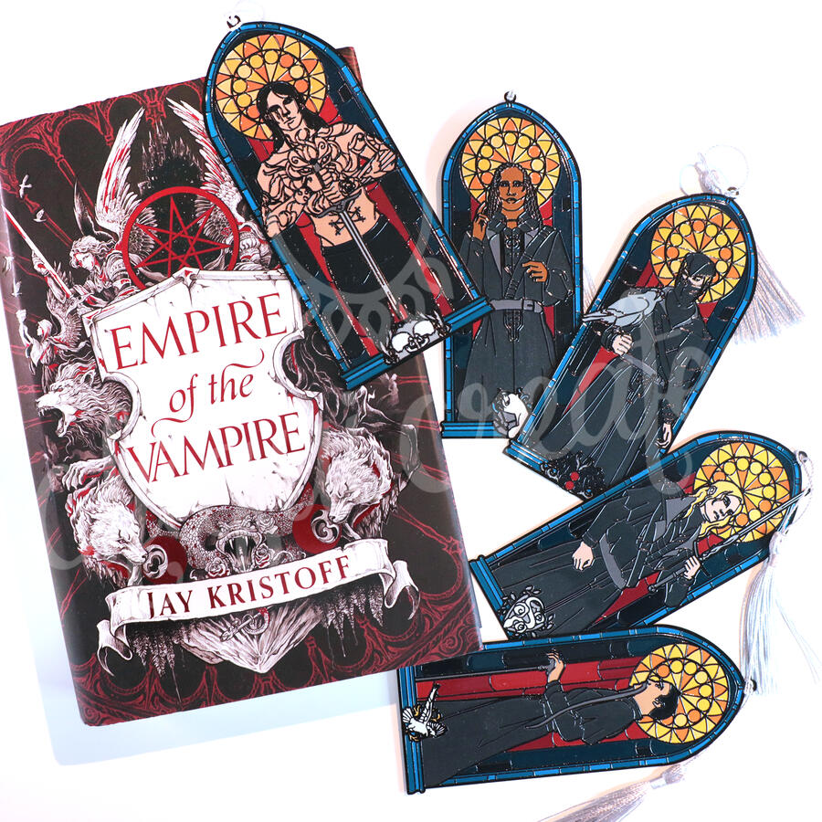 Five metal bookmarks of the five silversaints with the Empire of the Vampire Book beside them. Saints clockwise from upper left: Gabriel de Leon, Khalid, Greyhand, Aaron, and Talon.